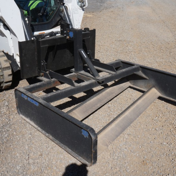 Blue diamond dual blade grader attachment on mini skid steer